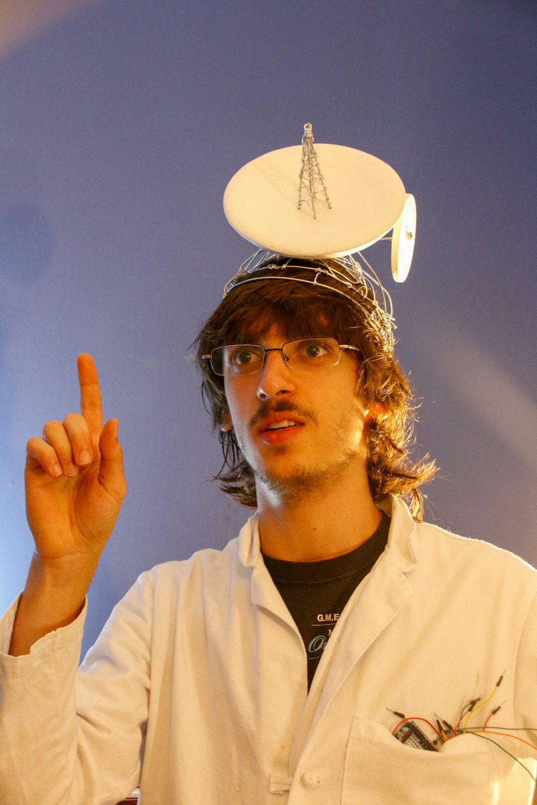 Studio portrait of a German male data scientist in his 30s with glasses